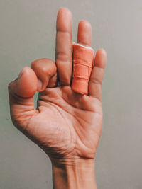 Close-up of person hand against wall