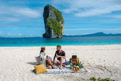 Couple enjoying picnic on beach