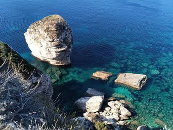 High angle view of rocks on sea