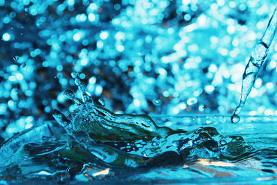 Close-up of water drops on blue surface