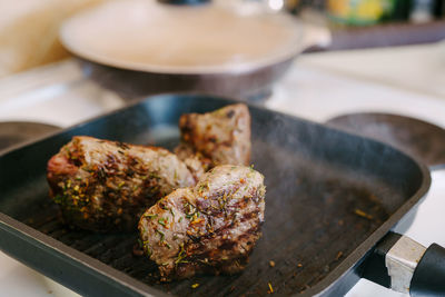 High angle view of meat on barbecue grill