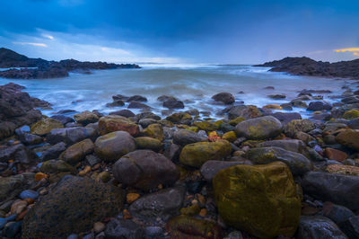 Rocks in sea against sky