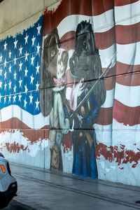 Low angle view of people with flag on glass wall