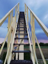 Low angle view of staircase by building against sky