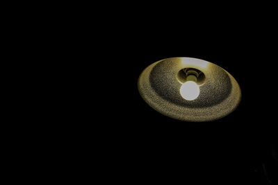 Close-up of illuminated lamp against black background