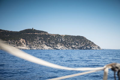 View of hill and tower of giunco, villasimius, sardinia, italy