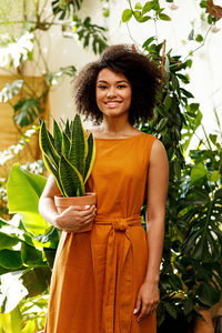 Portrait of a smiling young woman standing outdoors