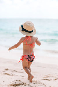 Rear view of child on beach