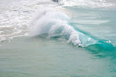 Waves breaking against sea