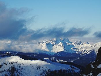 Scenic view of snowcapped mountains against blue sky