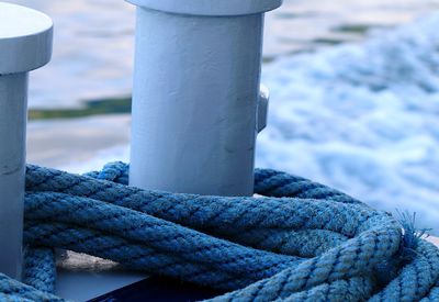 Close-up of rope tied to wooden post