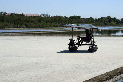 Man driving vehicle on salt flat