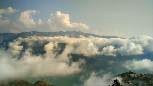 Scenic view of clouds over mountains against sky