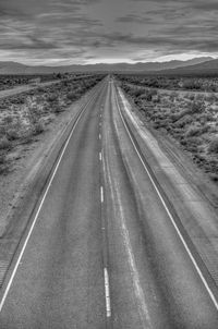 Empty country road against sky