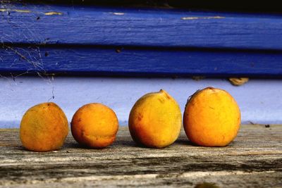 Close-up of oranges on wooden table
