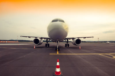 Airplane in the airport at sunset