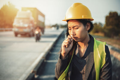 Engineer smelling medicine at construction site