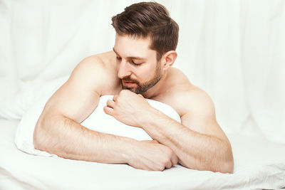 Portrait of young woman sleeping on bed at home
