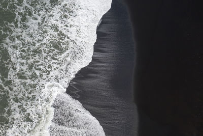Close-up of person standing on beach