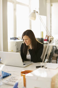 Businesswoman working on laptop at desk