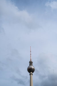 Low angle view of communications tower against sky