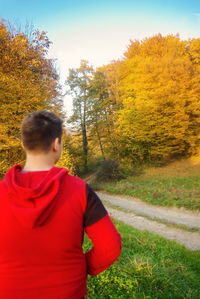 Rear view of man on field during autumn