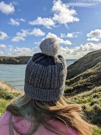 Rear view of woman looking at sea against sky