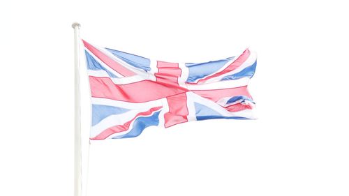 Low angle view of flags against the sky