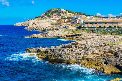 Aerial view of sea and buildings against sky