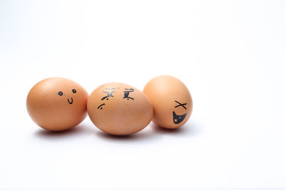 Close-up of eggs against white background