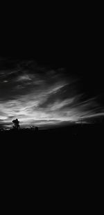 Scenic view of dramatic sky over silhouette landscape