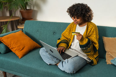 Young woman using laptop at home