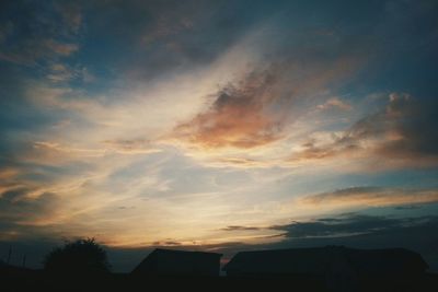 Low angle view of built structure against sky at sunset