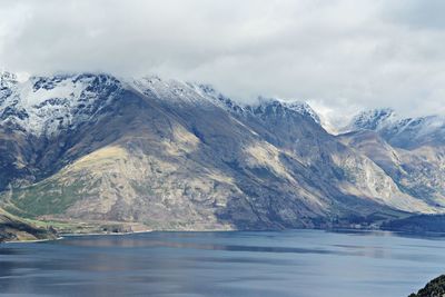 Scenic view of lake and mountains against sky