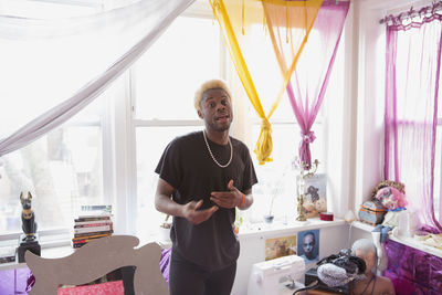 A young man in a bedroom