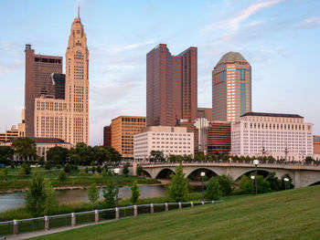 Buildings in city against cloudy sky