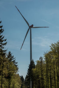 Low angle view of windmill against sky