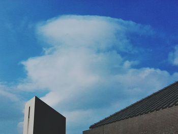 High section of building against blue sky