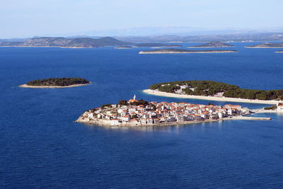 High angle view of townscape by sea against sky