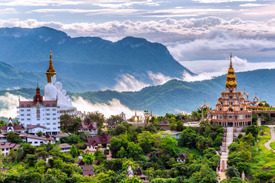 Cathedral of buildings against cloudy sky