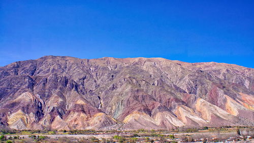 View of mountain range against blue sky