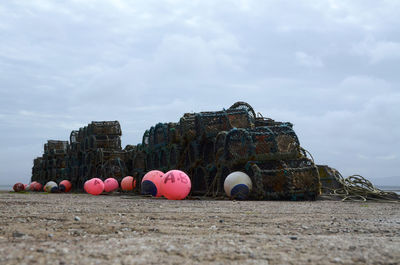 Lobster pots and floats sitting on a quay