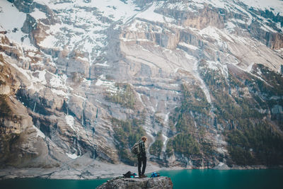 Man standing on rock by water
