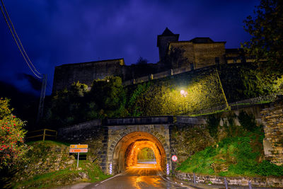 Arch bridge against sky at night