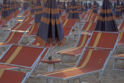 High angle view of people standing on empty chairs