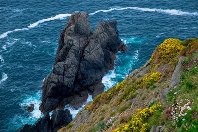 High angle view of rock formation by sea against sky