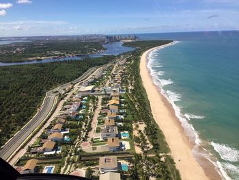 Aerial view of buildings by beach seen through helicopter