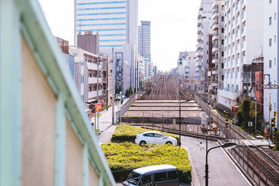 Cars on road in city against sky