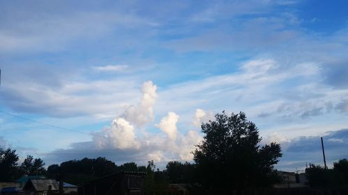 Buildings against cloudy sky