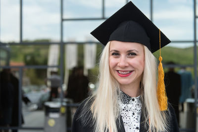 Portrait of woman wearing graduation gown